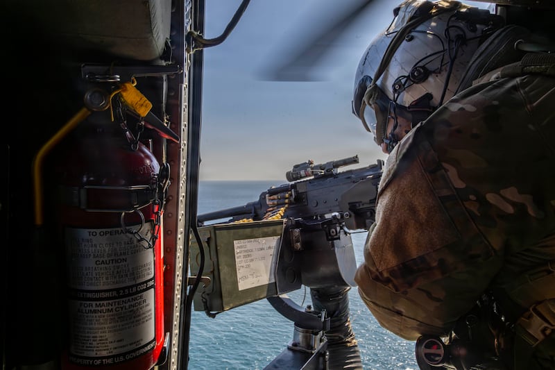 AT SEA - MARCH 03: (EDITOR’S NOTE: This Handout image was provided by a third-party organization and may not adhere to Getty Images’ editorial policy.) In this handout photo provided by the U.S. Navy, A U.S. Navy Sailor conducts flight operations in an MH-60S Sea Hawk helicopter, attached to Helicopter Sea Combat Squadron (HSC) 14, above Nimitz-class aircraft carrier USS Abraham Lincoln (CVN 72) in support of Operation Epic Fury on March 3, 2026 in the Mediterranean Sea. (Photo by U.S. Navy via Getty Images)
