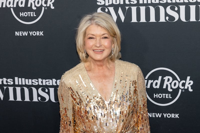 Martha Stewart arrives for the launch of the Sports Illustrated Swimsuit 2023 issue in a sparkling gold dress in 2023.