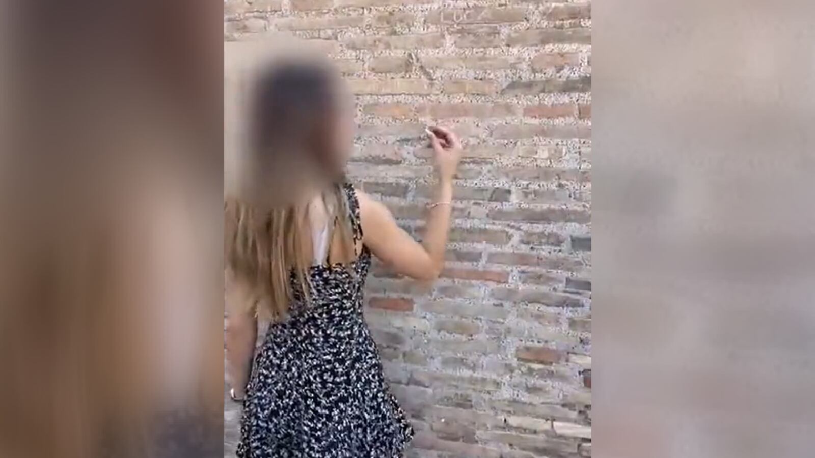 A teenage tourist from Switzerland etches her name into the Colosseum in Rome.