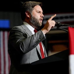 FILE PHOTO: Former U.S. president Donald Trump listens as JD Vance speaks during a rally in Youngstown, Ohio, U.S., September 17, 2022.  REUTERS/Gaelen Morse/File Photo