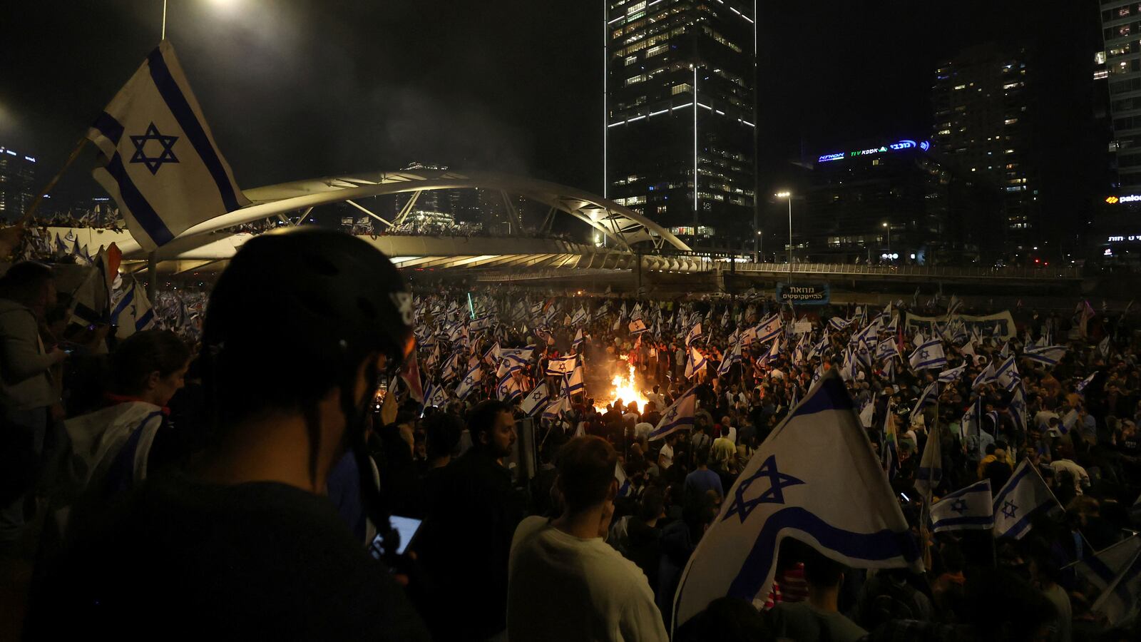 People attend a demonstration after Israeli Prime Minister Benjamin Netanyahu dismissed the defense minister and his nationalist coalition government presses on with its judicial overhaul, in Tel Aviv, Israel, March 26, 2023.