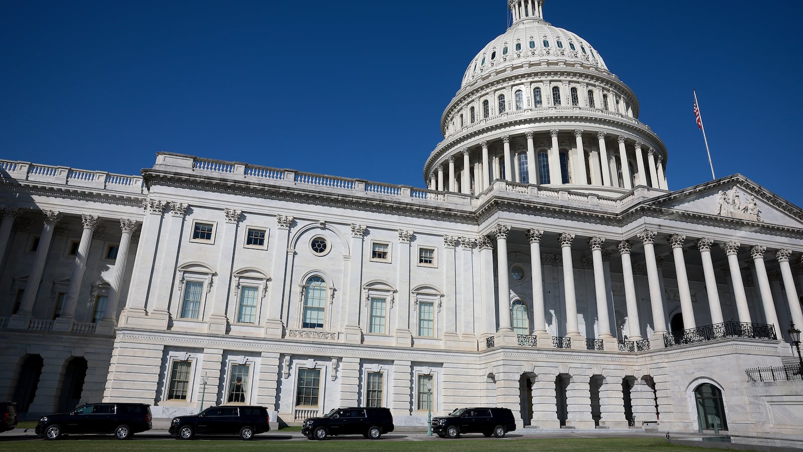 Vehicles are parked outside the U.S. Capitol building.