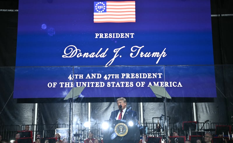 President Donald Trump speaks behind bulletproof glass during the kick-off celebration for the "Great American State Fair" on the National Mall in Washington, DC, June 24, 2026.