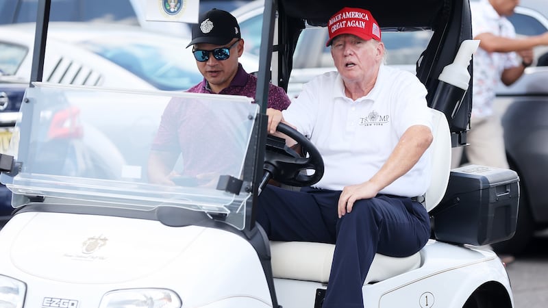 Former President Donald Trump drives a golf cart accompanied by aide Walt Nauta prior to the start of day three of the LIV Golf Invitational - Bedminster at Trump National Golf Club on Aug. 13, 2023 in Bedminster, New Jersey.