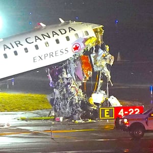 Emergency crews work around an Air Canada Express jet that had collided with a ground vehicle at New York's LaGuardia Airport in Queens, New York, U.S. March 23, 2026.