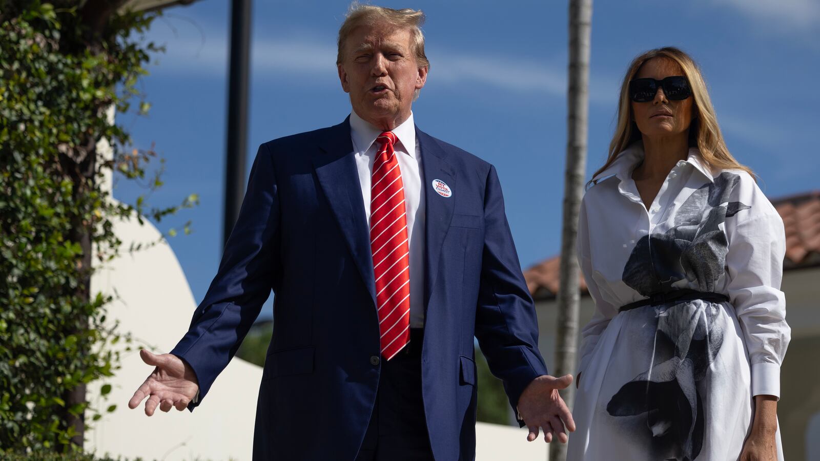 Former U.S. President Donald Trump and former first lady Melania Trump stand together as they speak with the media after voting at a polling station setup in the Morton and Barbara Mandel Recreation Center on March 19, 2024, in Palm Beach, Florida.