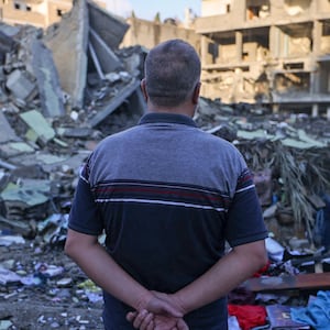 A Palestinian man looks on amid the rubble of buildings destroyed during Israeli airstrikes in the Rafah refugee camp in the southern of Gaza Strip.
