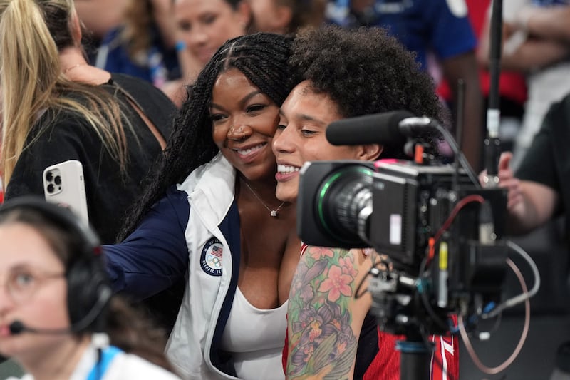 Aug 11, 2024; Paris, France; United States centre Brittney Griner (15) celebrates with her wife, Cherelle Griner, after defeating France in the women's gold medal game during the Paris 2024 Olympic Summer Games at Accor Arena. Mandatory Credit: James Lang-USA TODAY Sports