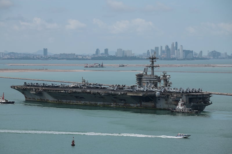 The U.S. Navy Nimitz-class aircraft carrier USS Abraham Lincoln sails toward Laem Chabang Port before docking for a rest stop following a long deployment in the Middle East, with the Pattaya skyline in backdrop, in Chonburi province, Thailand, September 2, 2026. REUTERS/Chalinee Thirasupa
