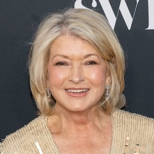 Martha Stewart arrives for the launch of the Sports Illustrated Swimsuit 2023 issue in a sparkling gold dress in 2023.