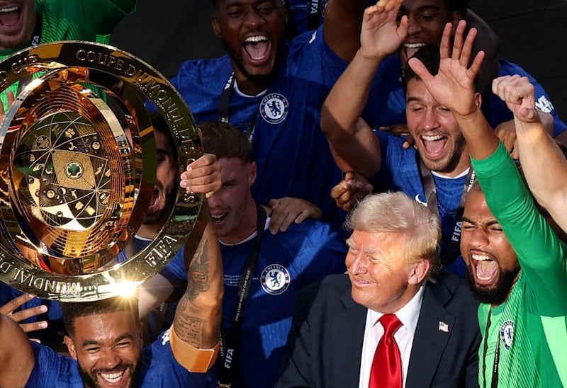 Soccer Football - FIFA Club World Cup - Final - Chelsea v Paris St Germain - MetLife Stadium, East Rutherford, New Jersey, U.S. - July 13, 2025 Chelsea's Reece James lifts the trophy as he celebrates with teammates after winning the FIFA Club World Cup as U.S. President Donald Trump looks on REUTERS/Amanda Perobelli
