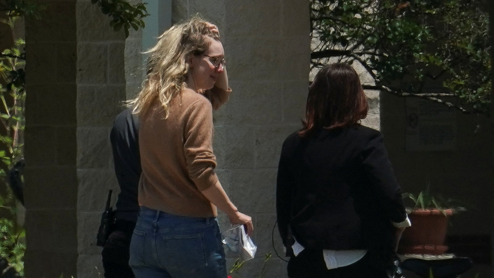 Theranos founder Elizabeth Holmes arrives at the Federal Prison Camp in Bryan, Texas, to begin serving her prison sentence. Her sentence has been cut by about two years, from 11-and-a-half years to nine.