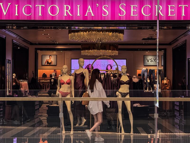 A woman walks past the entrance of Victoria's Secret store.