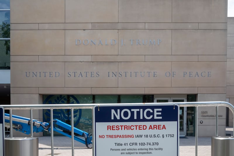 President Donald Trump's name, added to the United States Institute of Peace building months after Trump tried to dismantle the independent agency.