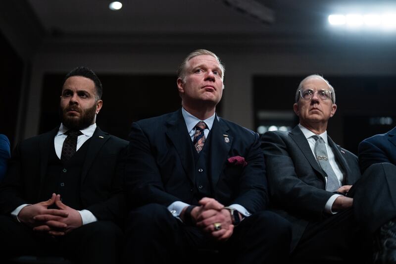 UNITED STATES - JANUARY 14: Timothy Parlatore, center, former attorney to President-elect Donald Trump, and Eric Ueland, right, listen to testimony by Pete Hegseth, Trump's nominee to be defense secretary, during his Senate Armed Services Committee confirmation hearing in Dirksen building on Tuesday, January 14, 2025. (Tom Williams/CQ-Roll Call, Inc via Getty Images)