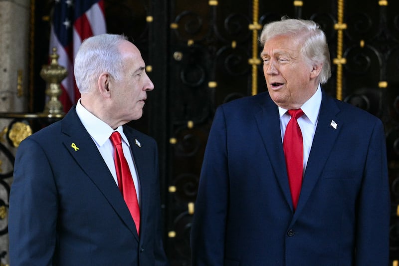 US President Donald Trump (R) greets Israeli Prime Minister Benjamin Netanyahu (L) upon arrival at Trump's Mar-a-Lago residence in Palm Beach, Florida, on December 29, 2025.