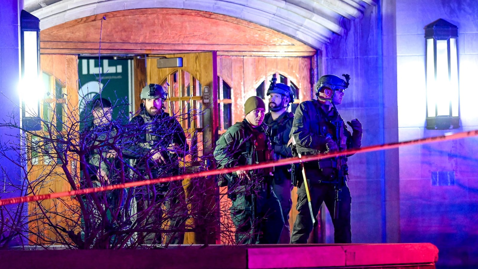 Police officers stand outside a dorm hall after the Michigan State shooting