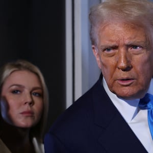 U.S. President Donald Trump speaks to members of the media next to White House Press Secretary Karoline Leavitt on board Air Force One en route to South Korea, October 29, 2025. REUTERS/Evelyn Hockstein