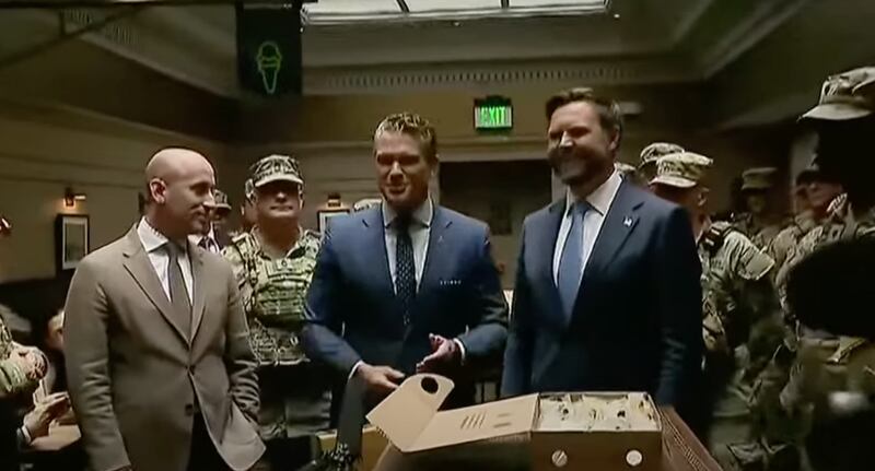 Defense Secretary Pete Hegseth gestured to some cheeseburgers while standing in a Shake Shack at Union Station with Vice President JD Vance and Stephen Miller on August 20.