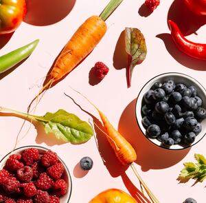 Pattern of variety fresh of organic berry fruits and vegetables and healthy vegan meal ingredients on pink background. Concept of food, vegetable, agriculture, harvest, food producer and healthy and vegetarian food.. Flat lay, top view