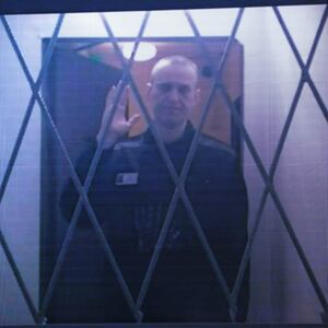 Jailed Russian opposition figure Alexei Navalny is seen on a screen via a video link from the IK-3 penal colony above the Arctic circle.