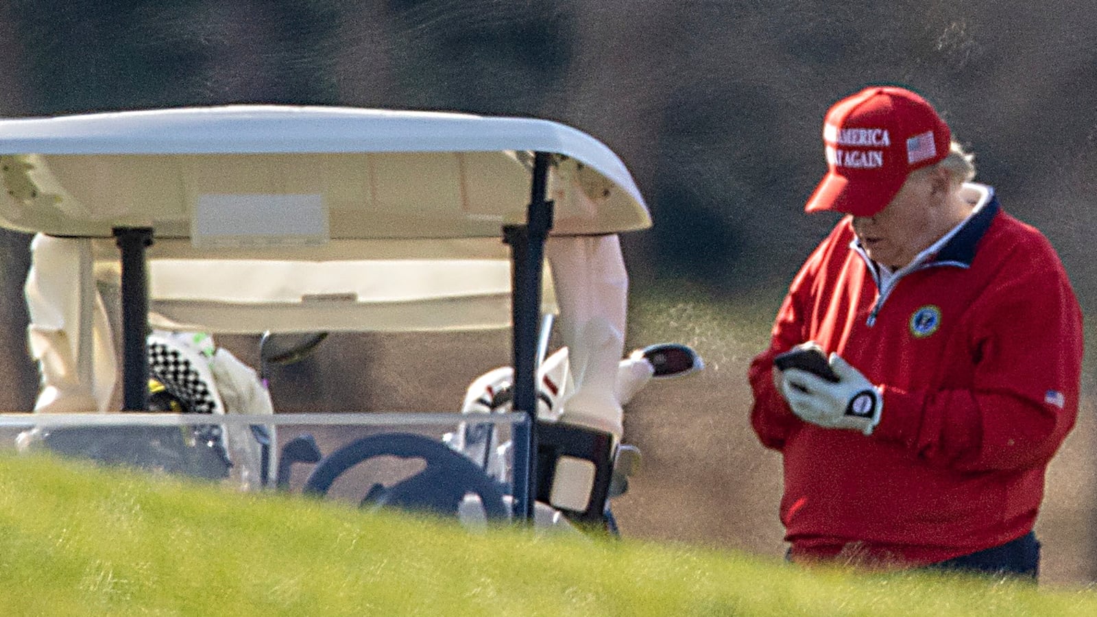 STERLING, VIRGINIA - NOVEMBER 26: US President Donald Trump makes a phone call as he golfs at Trump National Golf Club on November 26, 2020 in Sterling, Virginia. President Trump stayed in Washington, DC this year for Thanksgiving due the Covid-19 outbreak in the United States. (Photo by Tasos Katopodis/Getty Images)