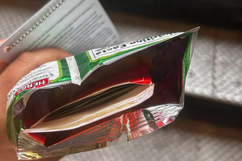 Former City Hall aide Winnie Greco handed THE CITY reporter Katie Honan an opened potato chip bag containing an envelope full of cash after a reelection event for Mayor Eric Adams in Harlem, Aug. 20, 2025.