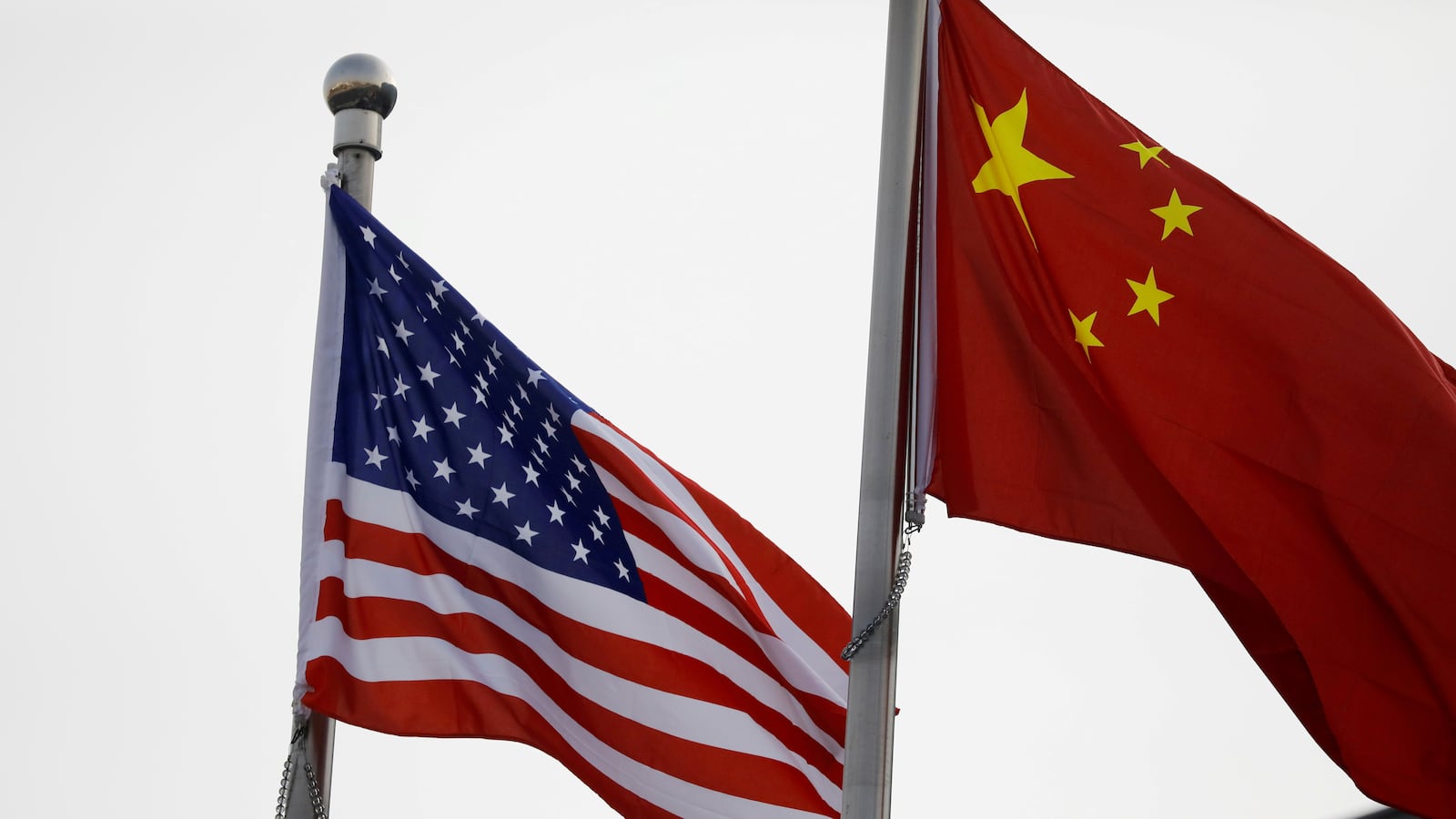 Chinese and U.S. flags flutter outside the building of an American company in Beijing, China, Jan. 21, 2021.