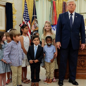 Children pose with U.S. President Donald Trump during an event to mark the launch of "Trump Accounts" in the Oval Office at the White House in Washington, D.C., U.S., July 6, 2026. REUTERS/Evan Vucci