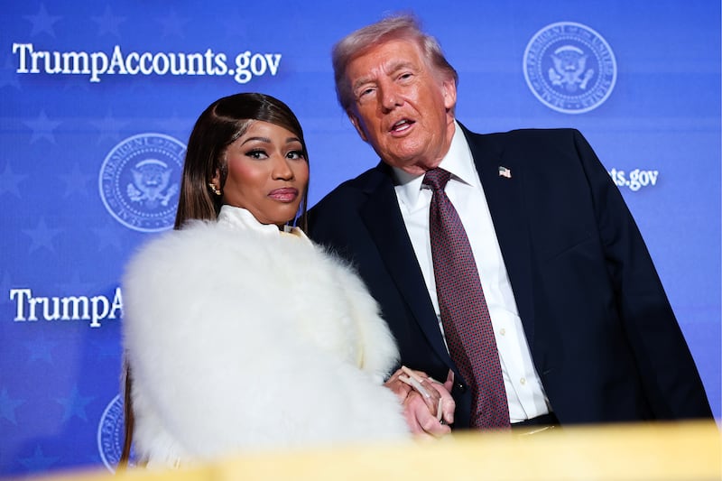 WASHINGTON, DC - JANUARY 28: Musician Nicki Minaj (L) joins U.S. President Donald Trump on stage as he delivers remarks during the Treasury Department's Trump Accounts Summit at Andrew W. Mellon Auditorium on January 28, 2026 in Washington, DC. "Trump Accounts" are a portion of recently passed tax and spending legislation where the federal government will deposit $1,000 into investment accounts for every child born between 2025 and 2028 once parents sign their children up while filing their income taxes.  (Photo by Win McNamee/Getty Images)