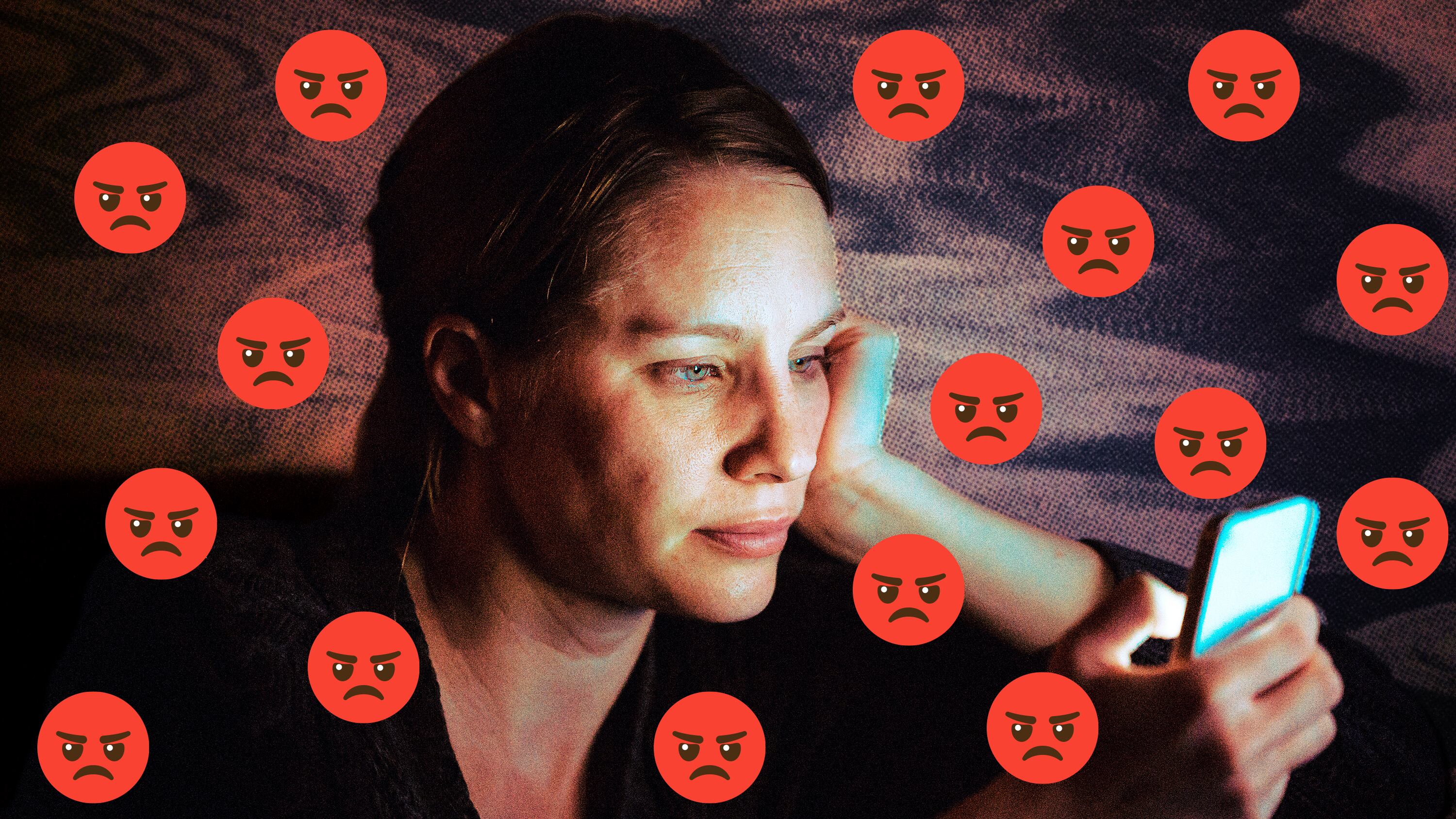 A photo illustration of a woman on her phone in the dark surrounded by angry emojis.