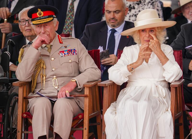 King Charles III and Queen Camilla react emotionally as they attend a Service of Remembrance to commemorate the 80th Anniversary of VJ Day