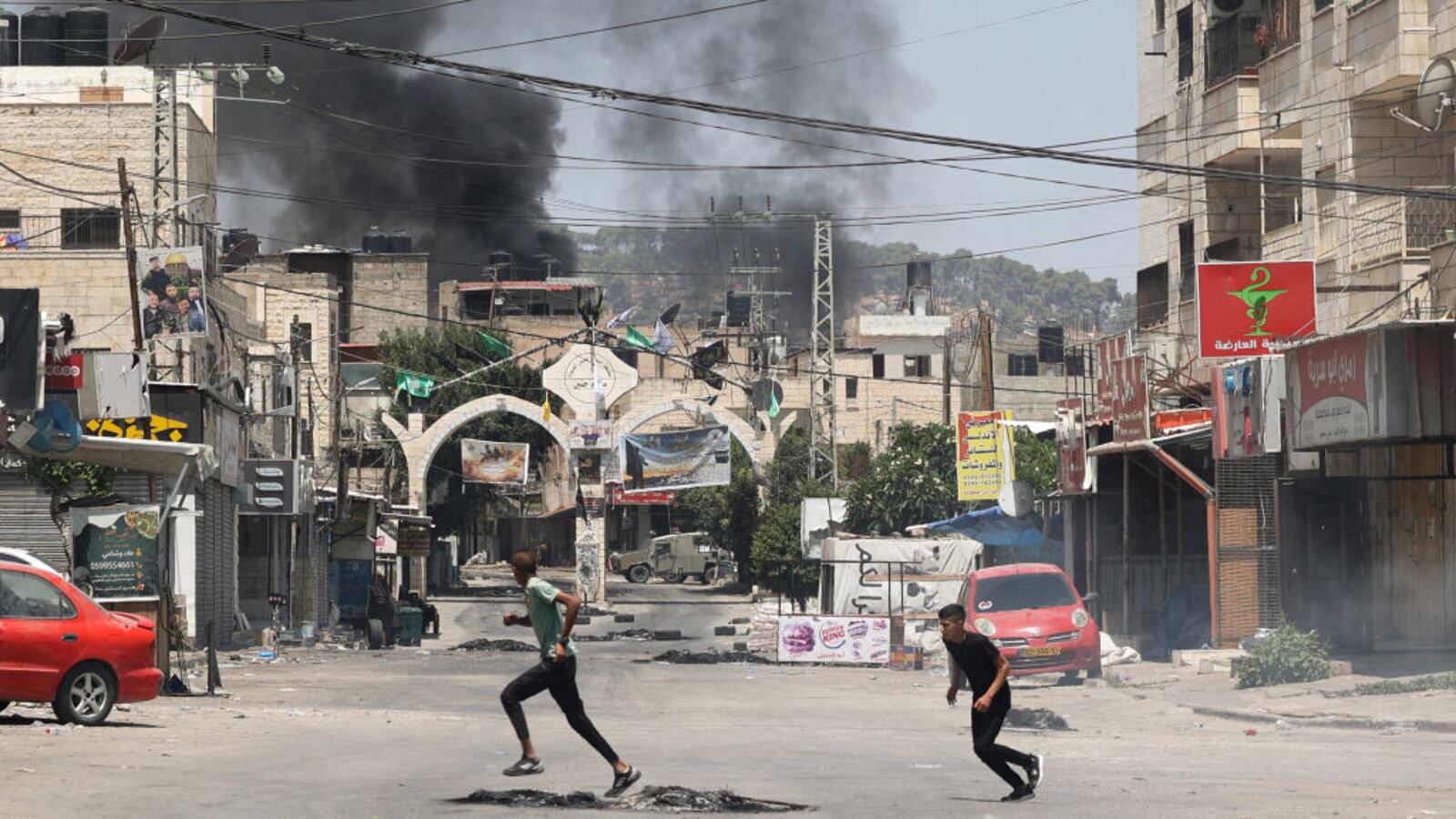 People run during the Isreal operation in Jenin in the West Bank which used drone strikes.
