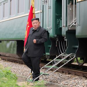North Korean leader Kim Jong Un steps off his green armored train.