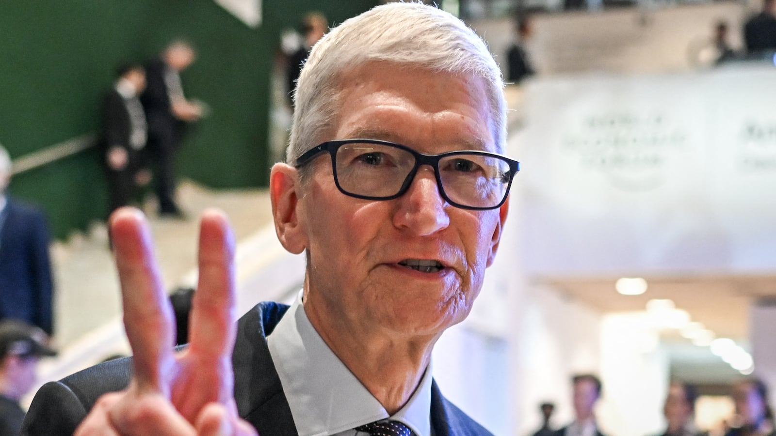 Apple CEO Tim Cook gestures as he departs after a business leaders reception with the US President on the sidelines of the World Economic Forum (WEF) annual meeting in Davos on January 21, 2026.