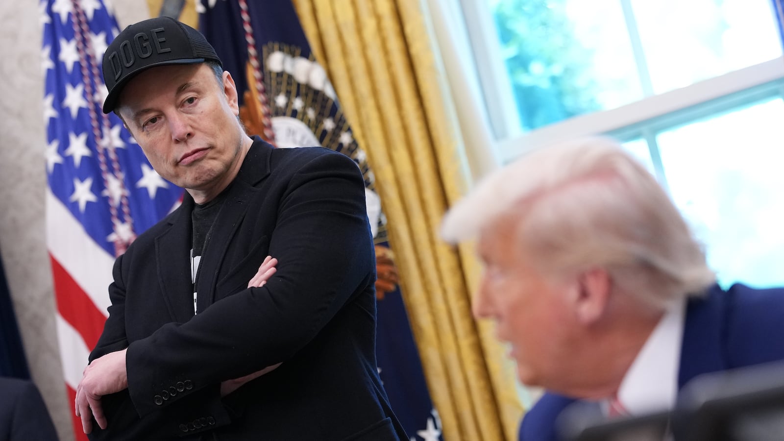 Elon Musk listens as U.S. President Donald Trump speaks to reporters in the Oval Office of the White House on May 30, 2025 in Washington, DC.