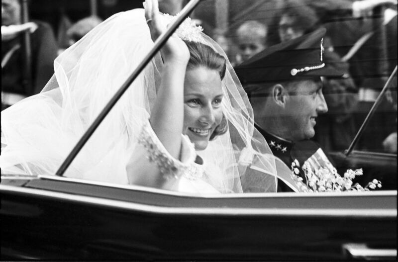 A picture taken on August 29, 1968, shows Harald, then Norway’s Crown Prince, and Sonja Haraldsen waving as they leave Oslo Cathedral in their car during their wedding ceremony.