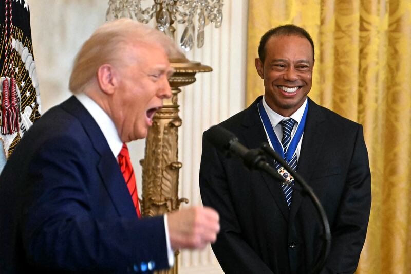 Donald Trump (left) awards the Medal of Freedom to Tiger Woods (right)
