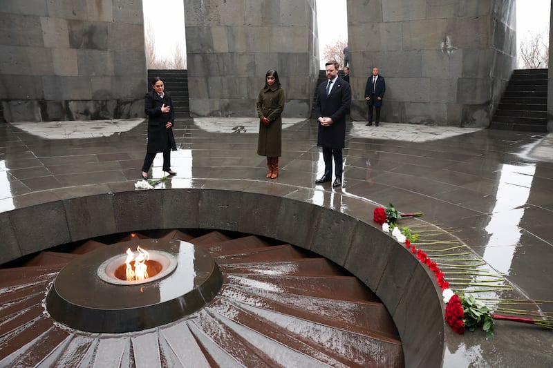 YEREVAN, ARMENIA - FEBRUARY 10:  Edita G. Gzoyan (L), director of the Armenian Genocide Museum-Institute, U.S. Vice President JD Vance and wife Usha Vance pay tribute at the eternal flame during a visit to the Tsitsernakaberd Armenian Genocide Memorial on February 10, 2026 in Yerevan, Armenia. In the first visit to Armenia of a sitting U.S. vice president, Vance is meeting Armenian Prime Minister Nikol Pashinyan, who signed a deal intended to reopen key transportation routes with Azerbaijan. (Photo by Kevin Lamarque-Pool/Getty Images)