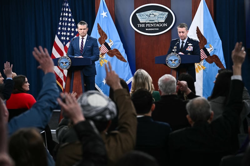 (L/R) US Defense Secretary Pete Hegseth and the Chairman of the Joint Chiefs of Staff General Dan Caine take questions during a press conference on US military action in Iran, at the Pentagon in Washington, DC, on March 2, 2026. The United States hit hundreds of targets across Iran, and Israel expanded its bombing to Lebanon on Monday as President Donald Trump vowed to avenge the first US deaths in the war he launched to topple Tehran's ruling clerics. Iranian forces fired missiles and drones across the Middle East, killing people in Israel and the United Arab Emirates, in retaliation for the conflict that began February 28 with the death of Iran's supreme leader, Ayatollah Ali Khamenei. (Photo by Brendan SMIALOWSKI / AFP via Getty Images)
