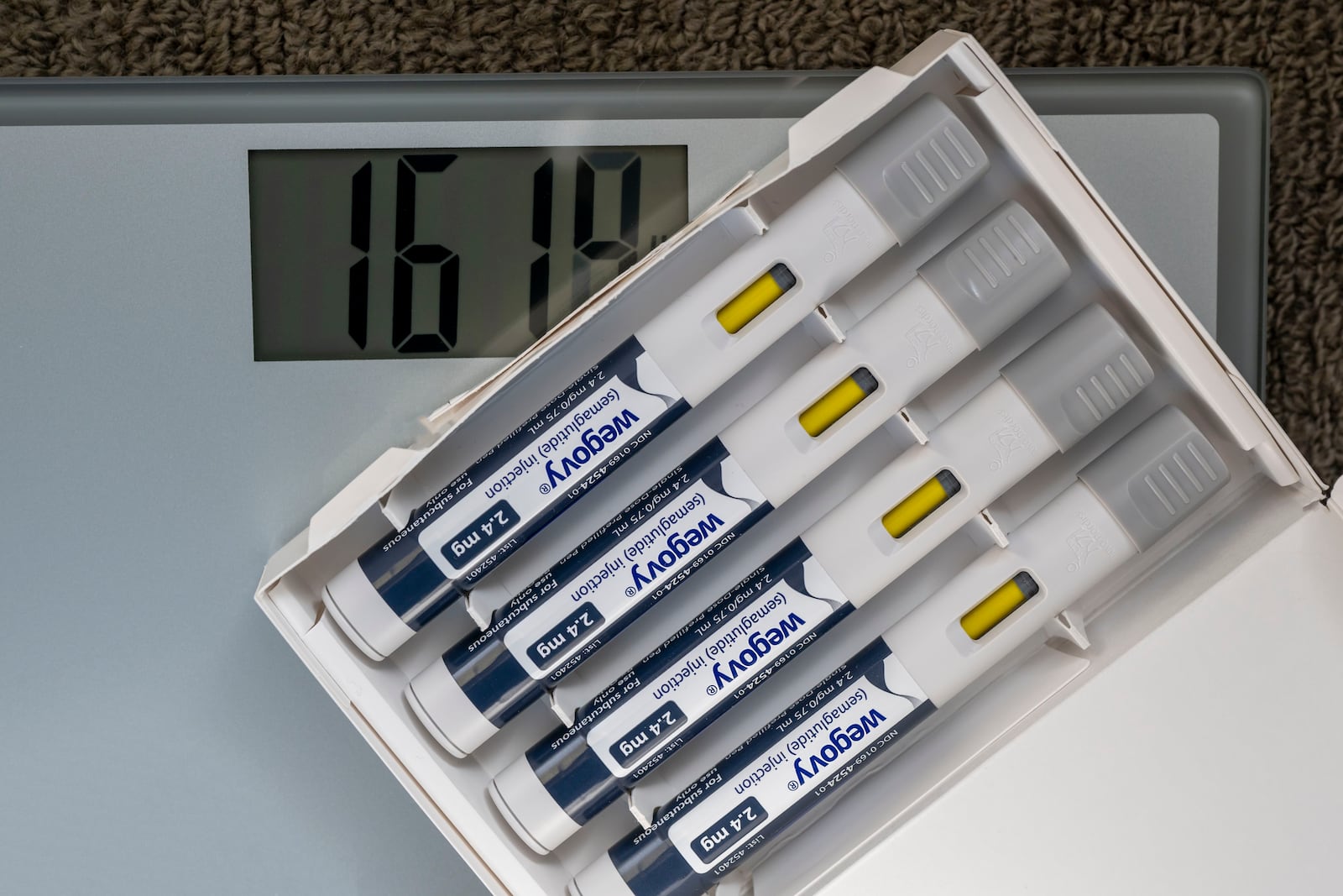 Photo illustration of Wegovy and a weight scale.