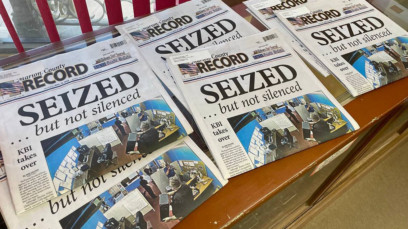 Copies of the Marion County Record scattered on a surface.
