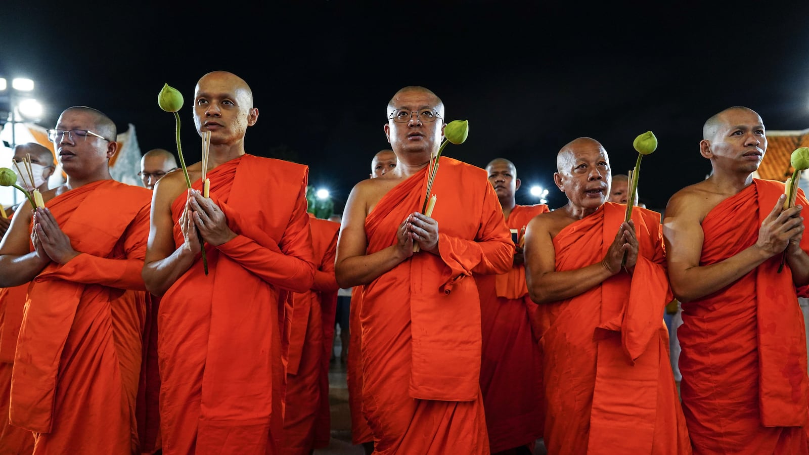 Thai Buddhist monks gather and hold lotus flowers, candles, and joss sticks as they circulate in prayer around Wat Benchamabopitr, or The Marble Temple, to celebrate Visakha Bucha Day in Bangkok, Thailand, on May 11, 2025. Visakha Bucha Day, on the full-moon day of the sixth lunar month, is an annual celebration of Buddha's birth, enlightenment, and death. (Photo by Anusak Laowilas/NurPhoto via Getty Images)