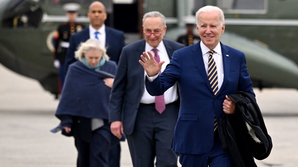 President Joe Biden, followed by US Senate Majority Leader Chuck Schumer (D-NY), US Senator Kirsten Gillibrand (D-NY), and US Senator Cory Booker (D-NJ), walks to board Air Force One at John F. Kennedy (JFK) International Airport in New York City.