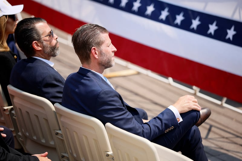 Eric Trump and Donald Trump Jr watched their father's speech at Burning Hills Amphitheater. It wasn't clear what they thought of his "threesome" joke.