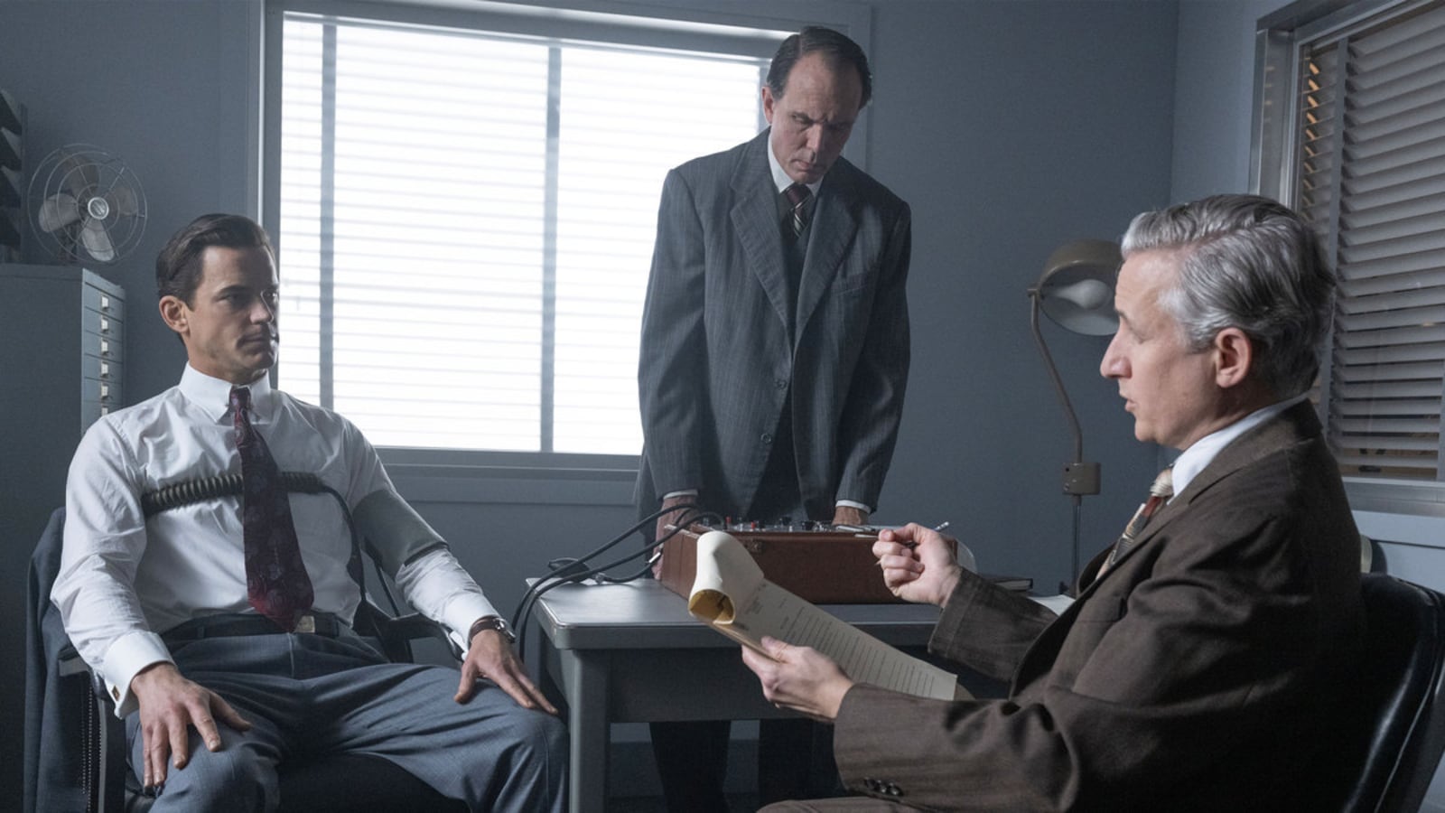 Matt Bomer as Hawkins "Hawk" Fuller takes a lie detecter test in a still from Fellow Travelers.