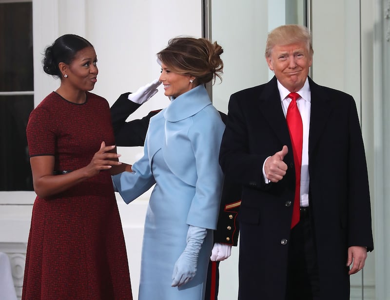 WASHINGTON, DC - JANUARY 20: President-elect Donald Trump gives a thumbs up, as his wife Melania Trump (C), first lady Michelle Obama, upon arriving at the White House on January 20, 2017 in Washington, DC. Later in the morning President-elect Trump will be sworn in as the nation's 45th president during an inaugural ceremony at the U.S. Capitol. (Photo by Mark Wilson/Getty Images)