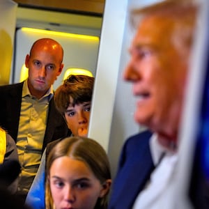 President Donald Trump (R), accompanied by White House press secretary Karoline Leavitt (L), White House Deputy Chief of Staff Stephen Miller