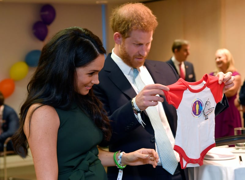 Harry and Meghan view a gift for their son Archie as they attend the WellChild awards at Royal Lancaster Hotel on October 15, 2019 in London, England.