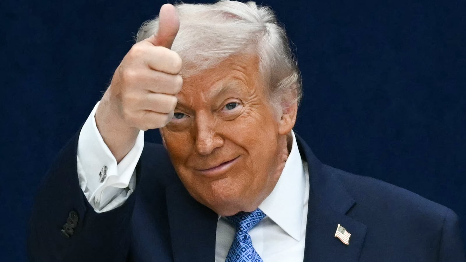 President Donald Trump gives a thumbs up as he departs the stage during the signing ceremony on December 4, 2025.